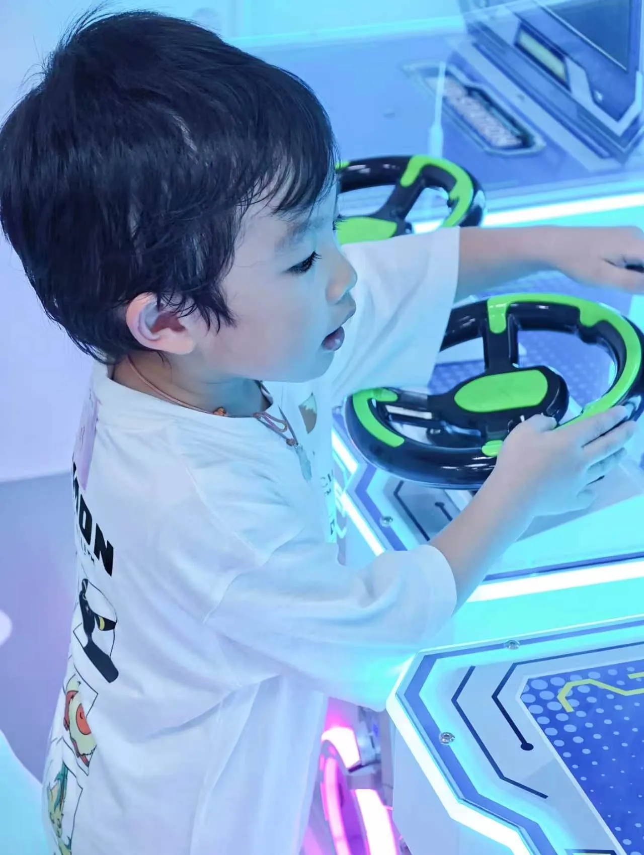 Child at the driving arcade game, Kidstation North Point